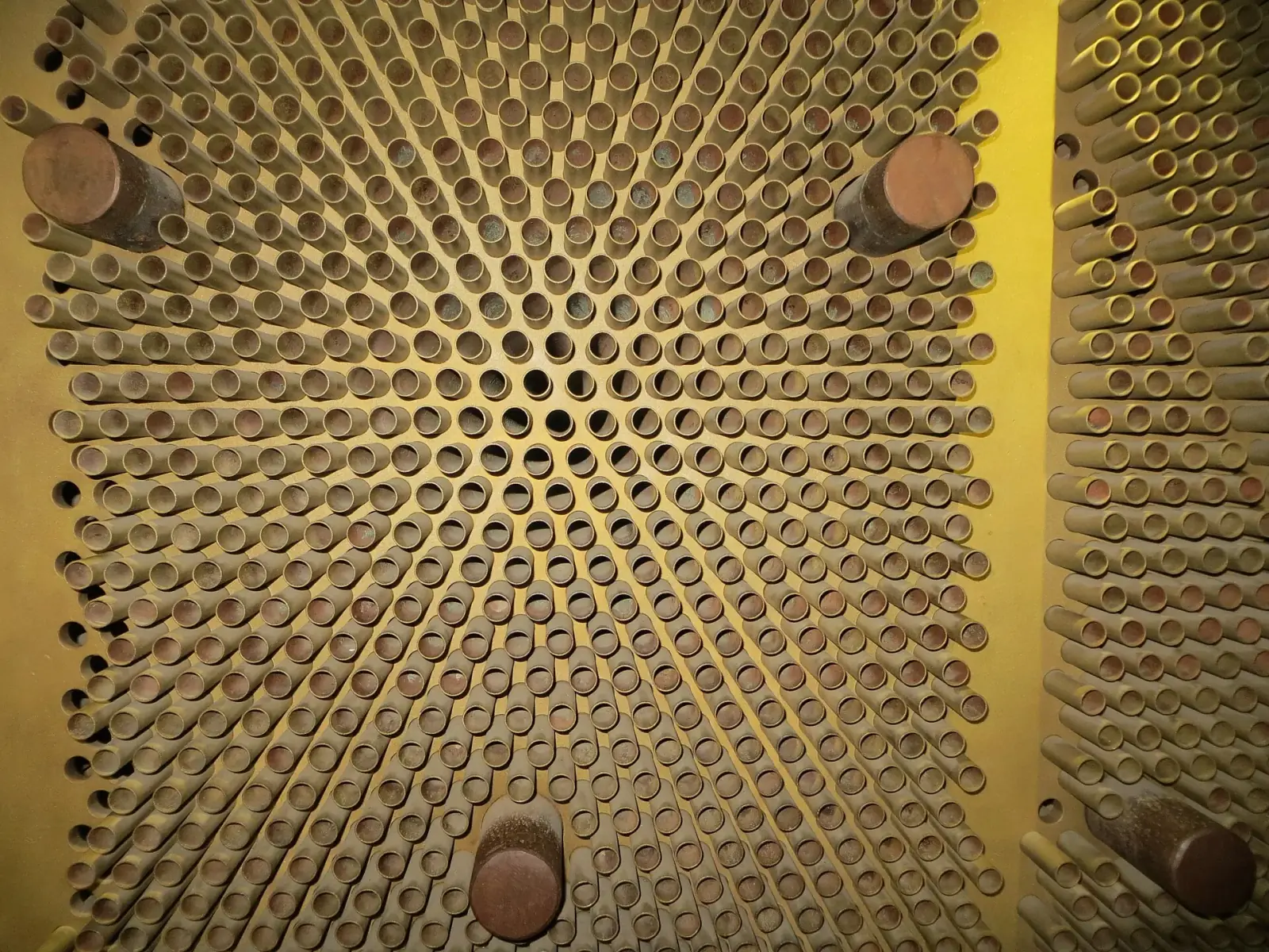 Dense array of metal tubes inside an industrial steam condenser