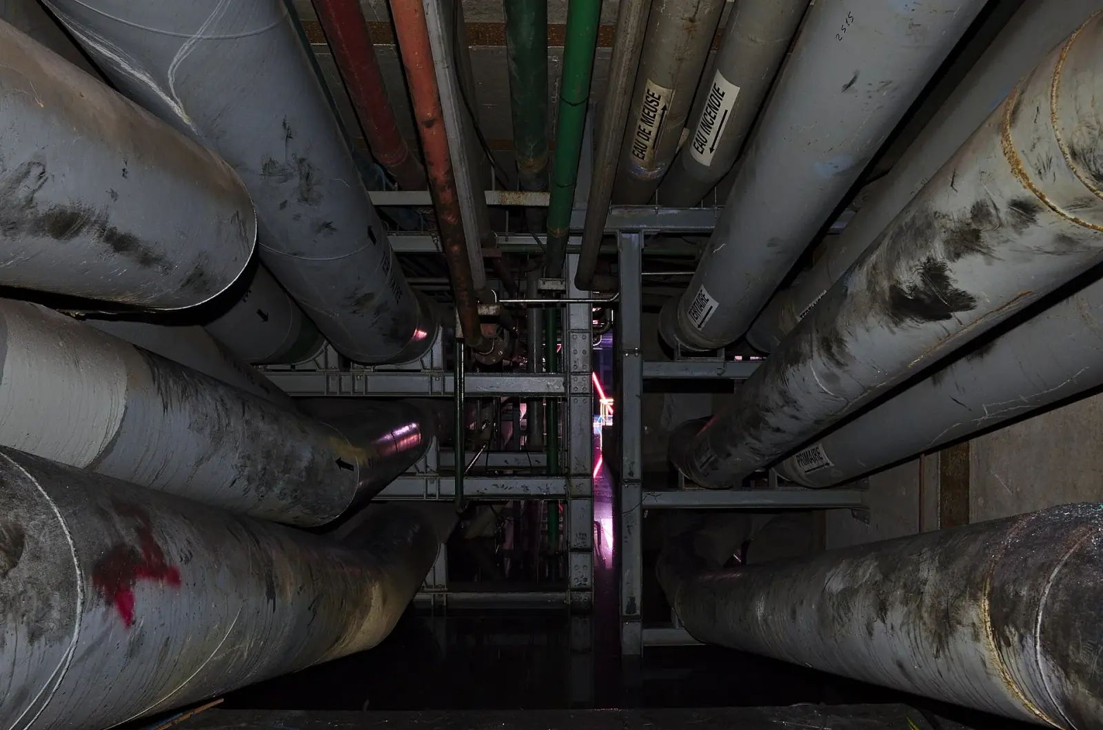 Dense overhead pipework inside an industrial water-treatment facility